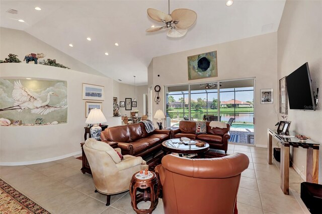 living room with light tile patterned floors, high vaulted ceiling, and ceiling fan