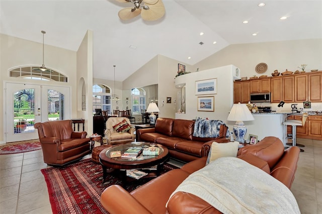 tiled living room with french doors, high vaulted ceiling, and ceiling fan