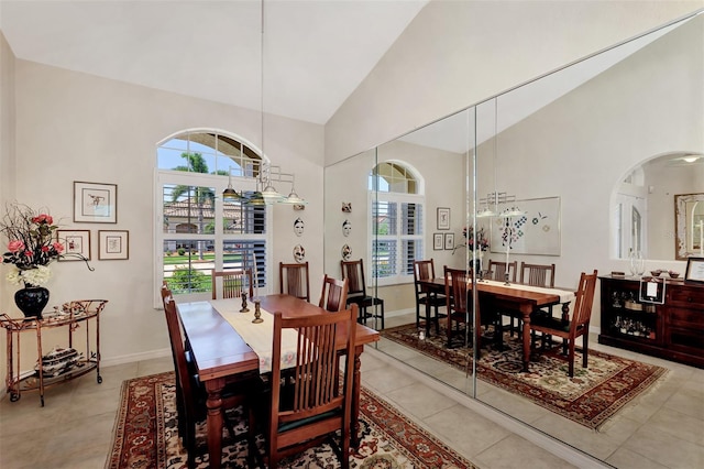 tiled dining room with high vaulted ceiling