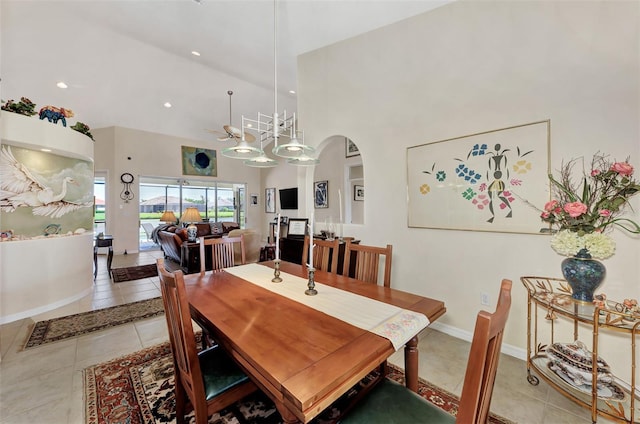 tiled dining room featuring ceiling fan and high vaulted ceiling