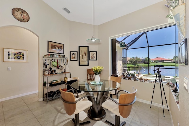 tiled dining area featuring a water view