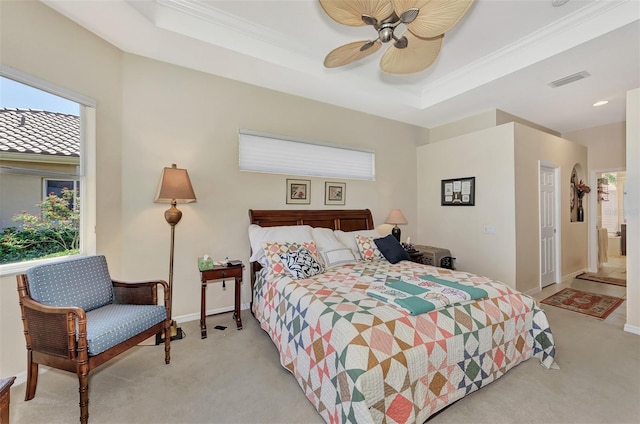 carpeted bedroom featuring connected bathroom, a raised ceiling, ceiling fan, and crown molding