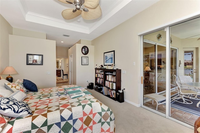 bedroom featuring ceiling fan, a raised ceiling, crown molding, carpet floors, and a closet