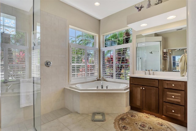 bathroom featuring tile patterned flooring, shower with separate bathtub, and a healthy amount of sunlight