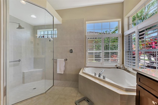 bathroom with tile patterned flooring, shower with separate bathtub, vanity, and a healthy amount of sunlight