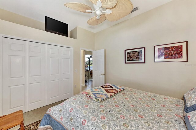 bedroom featuring ceiling fan, a closet, and a high ceiling