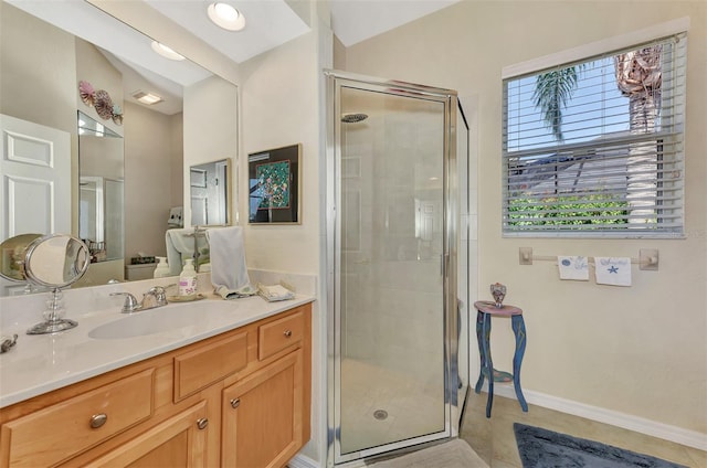 bathroom featuring tile patterned flooring, vanity, and a shower with shower door