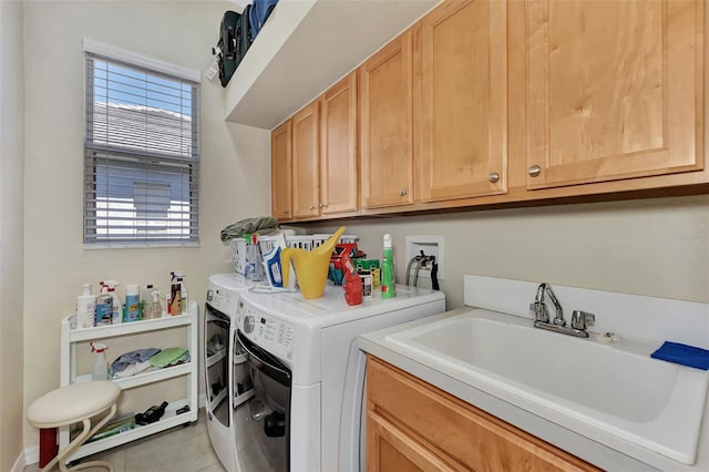 clothes washing area with washing machine and clothes dryer, sink, light tile patterned floors, and cabinets