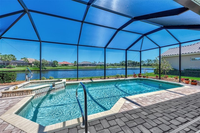 view of swimming pool featuring glass enclosure, an in ground hot tub, a patio area, and a water view