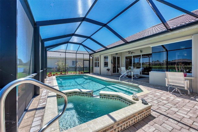 view of swimming pool featuring a patio, glass enclosure, and ceiling fan