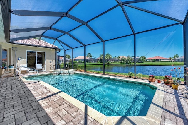 view of pool with glass enclosure, a patio area, and a water view