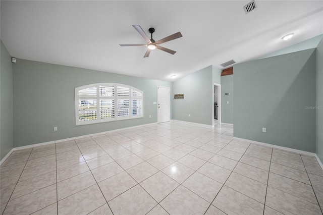 tiled spare room featuring ceiling fan and vaulted ceiling