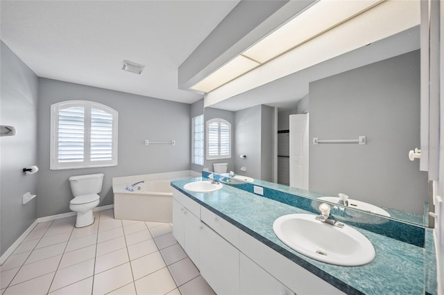 bathroom with toilet, a bath, vanity, and tile patterned floors