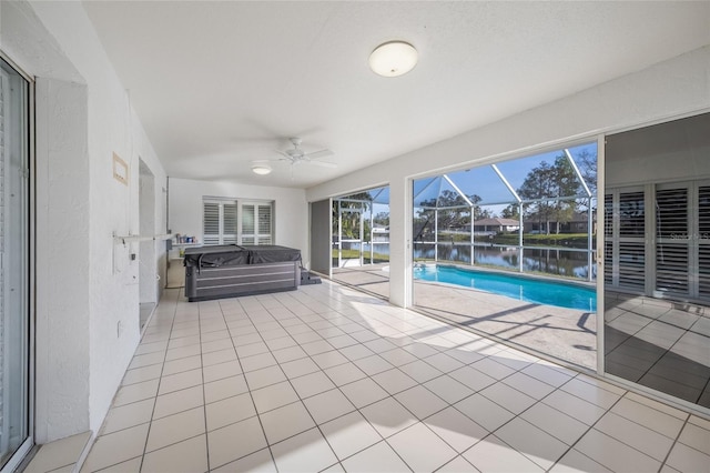 view of swimming pool featuring a water view and ceiling fan