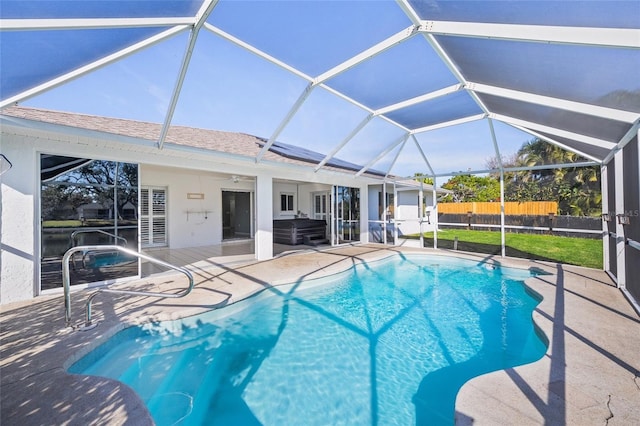 view of swimming pool featuring a lanai, ceiling fan, and a patio area