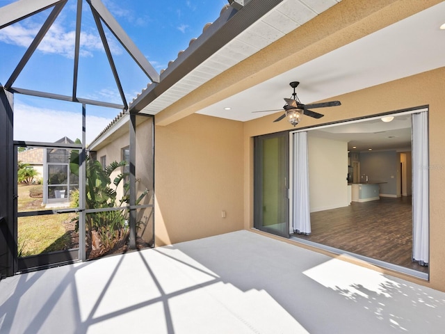 view of patio / terrace featuring ceiling fan and a lanai