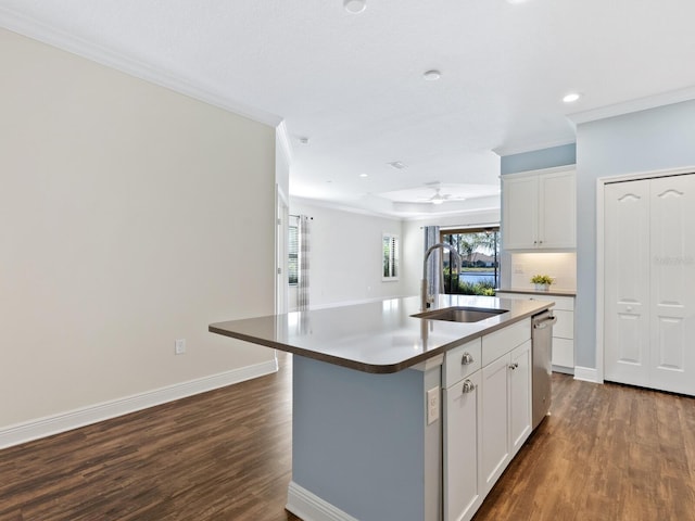 kitchen with sink, a kitchen island with sink, white cabinetry, and dark hardwood / wood-style flooring