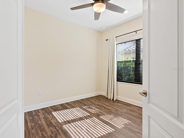 empty room with dark wood-type flooring and ceiling fan