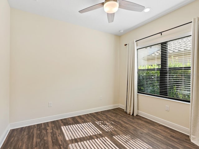 spare room with ceiling fan, dark wood-type flooring, and a healthy amount of sunlight