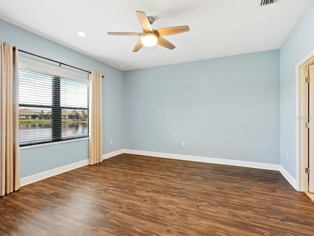 unfurnished room featuring ceiling fan and dark hardwood / wood-style flooring