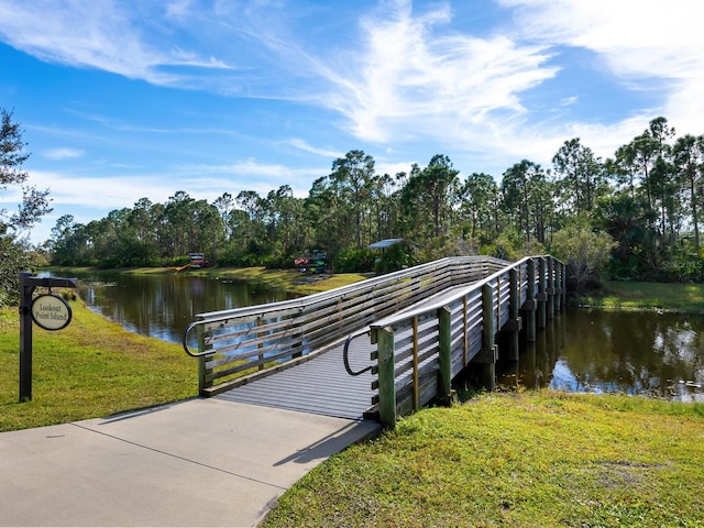 view of dock featuring a yard and a water view