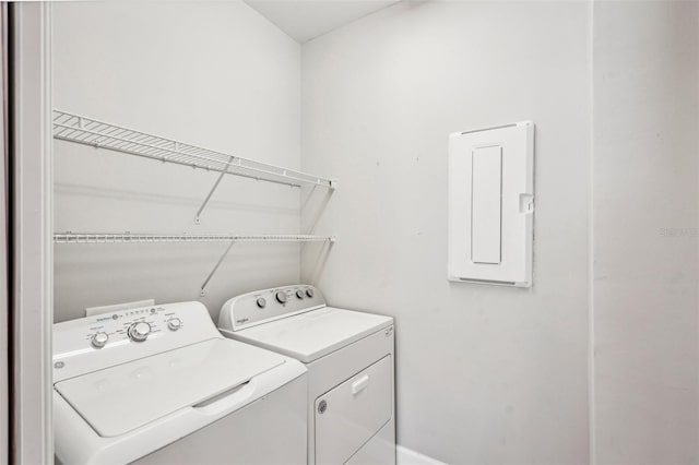 washroom with washing machine and dryer and electric panel