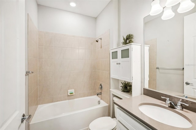 full bathroom featuring vanity, tiled shower / bath combo, and toilet