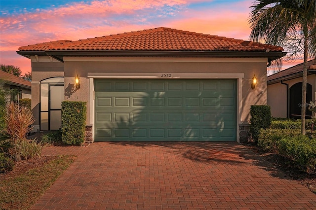 2572 Daisy Dr, North Port, FL 34289 - view of front of property with decorative driveway, a garage, stucco siding, and a tile roof