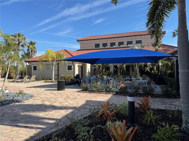 2572 Daisy Dr, North Port, FL 34289 - back of house featuring a patio, a tile roof, outdoor dining space, and stucco siding