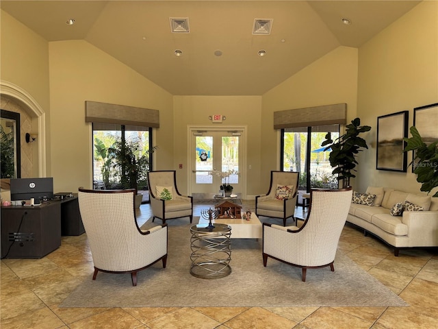 tiled living room with high vaulted ceiling