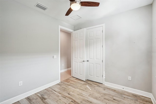 unfurnished bedroom with ceiling fan, a closet, and light hardwood / wood-style flooring