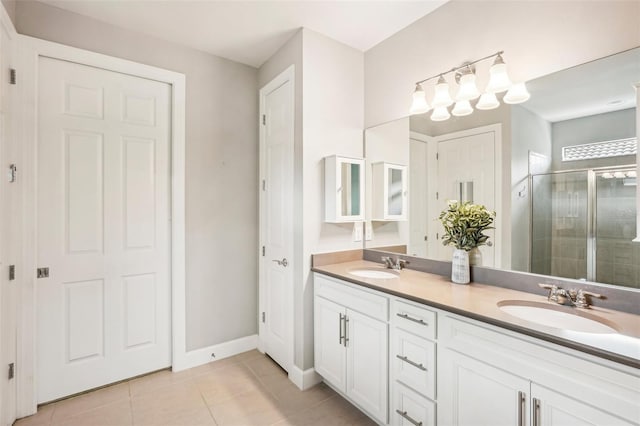 bathroom with tile patterned floors, a shower with door, and vanity