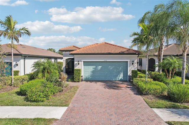 mediterranean / spanish-style home with a garage