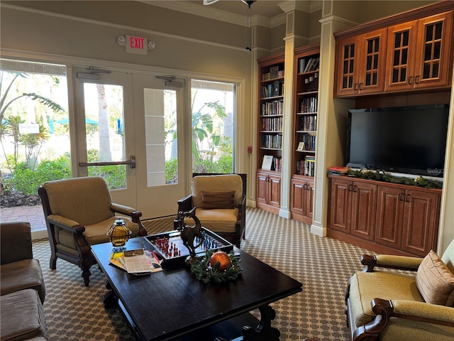 2572 Daisy Dr, North Port, FL 34289 - carpeted living room with ornamental molding and built in shelves