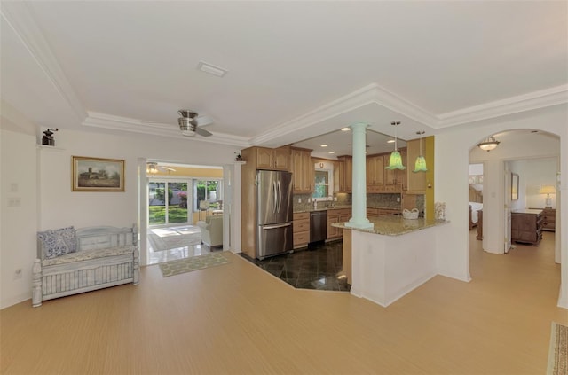 kitchen featuring dark hardwood / wood-style floors, kitchen peninsula, decorative light fixtures, decorative backsplash, and appliances with stainless steel finishes