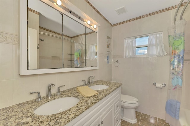 bathroom featuring backsplash, tile patterned flooring, toilet, tile walls, and curtained shower