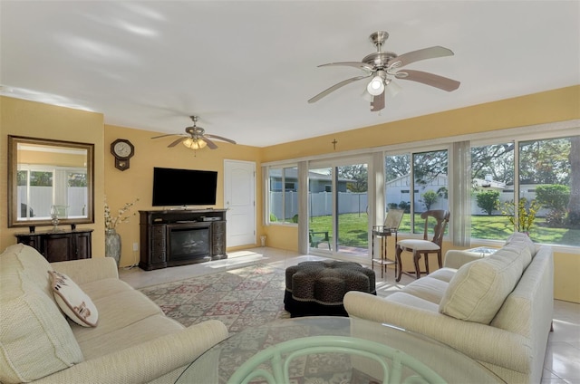 living room with light tile patterned floors, ceiling fan, and a healthy amount of sunlight