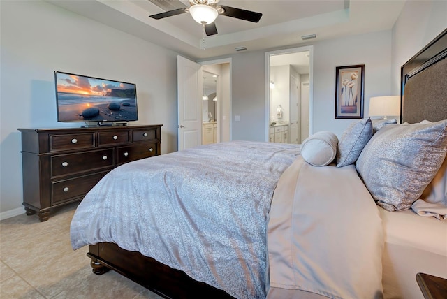 bedroom featuring ceiling fan, connected bathroom, and a raised ceiling