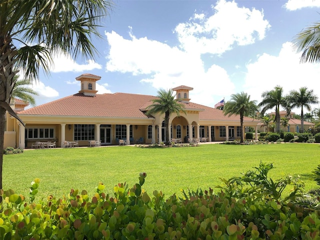 rear view of property featuring a yard