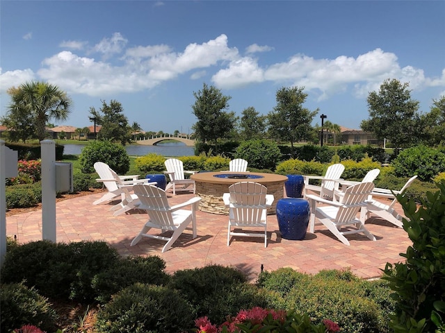 view of patio / terrace featuring a water view and an outdoor fire pit