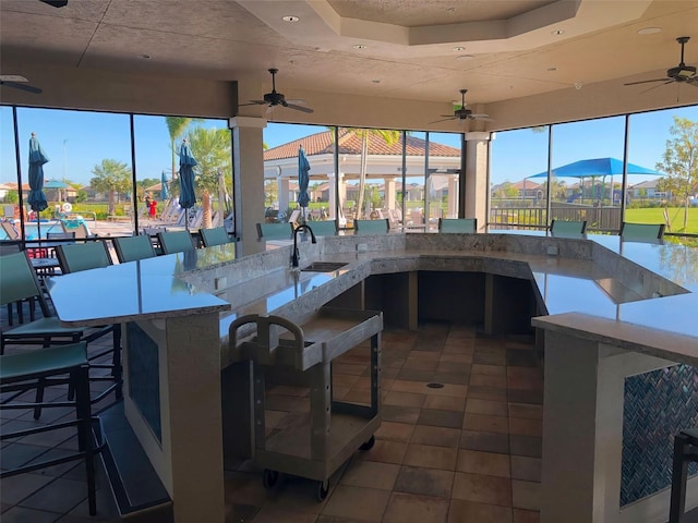 view of patio featuring ceiling fan and an outdoor wet bar