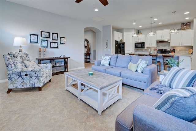 tiled living room featuring ceiling fan