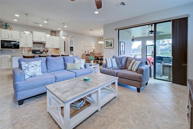 living room with light tile patterned floors and a notable chandelier