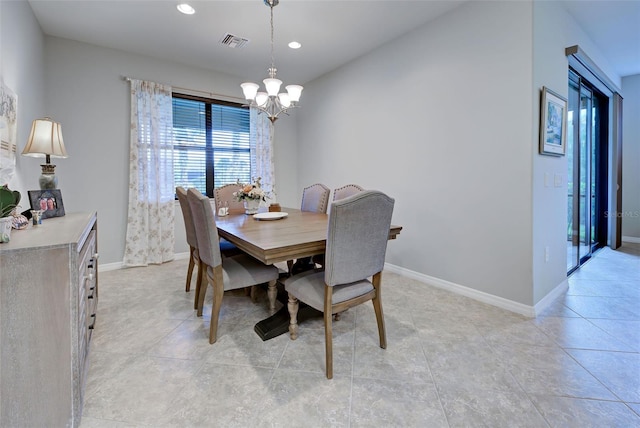 dining space with light tile patterned floors and a notable chandelier