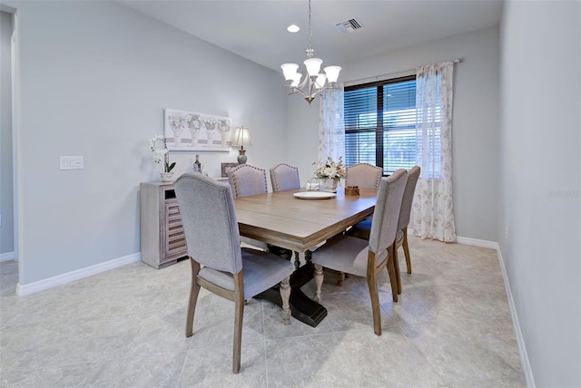 dining area featuring an inviting chandelier