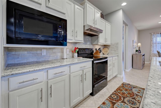 kitchen with white cabinets, black appliances, tasteful backsplash, light tile patterned flooring, and light stone counters