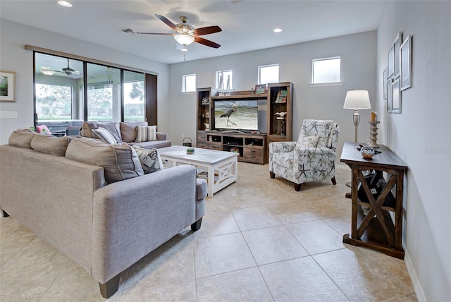 living room with ceiling fan, light tile patterned floors, and a healthy amount of sunlight