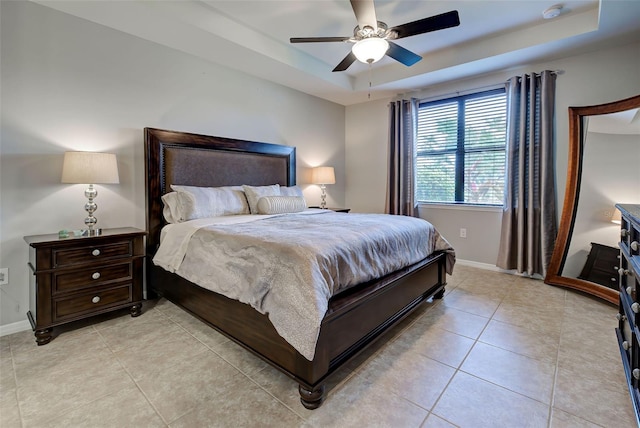 bedroom featuring ceiling fan and a raised ceiling