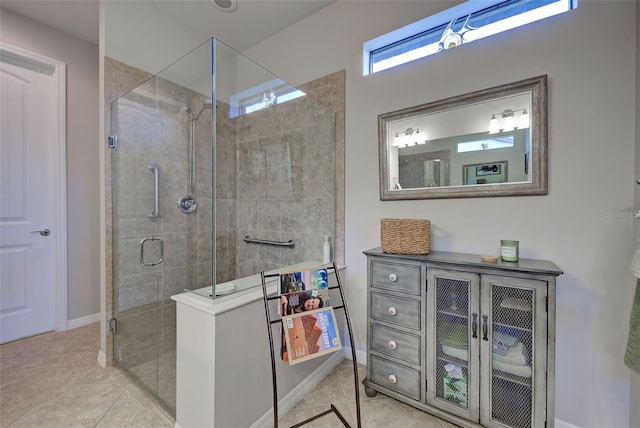 bathroom with tile patterned floors and a shower with door