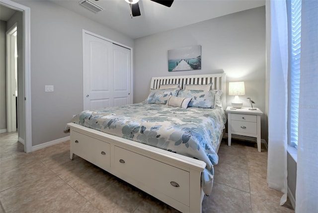 tiled bedroom with a closet and ceiling fan